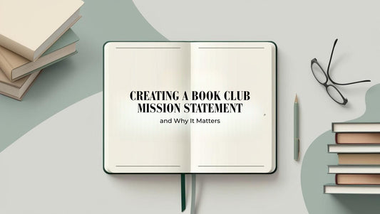 Open notebook with the words "mission statement" written, surrounded by books and pens on a clean table