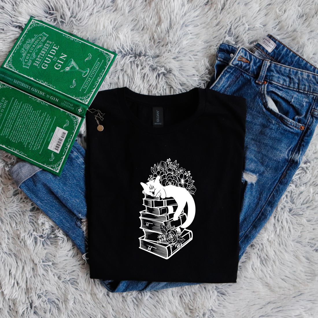 Cat sleeping on books flowers
