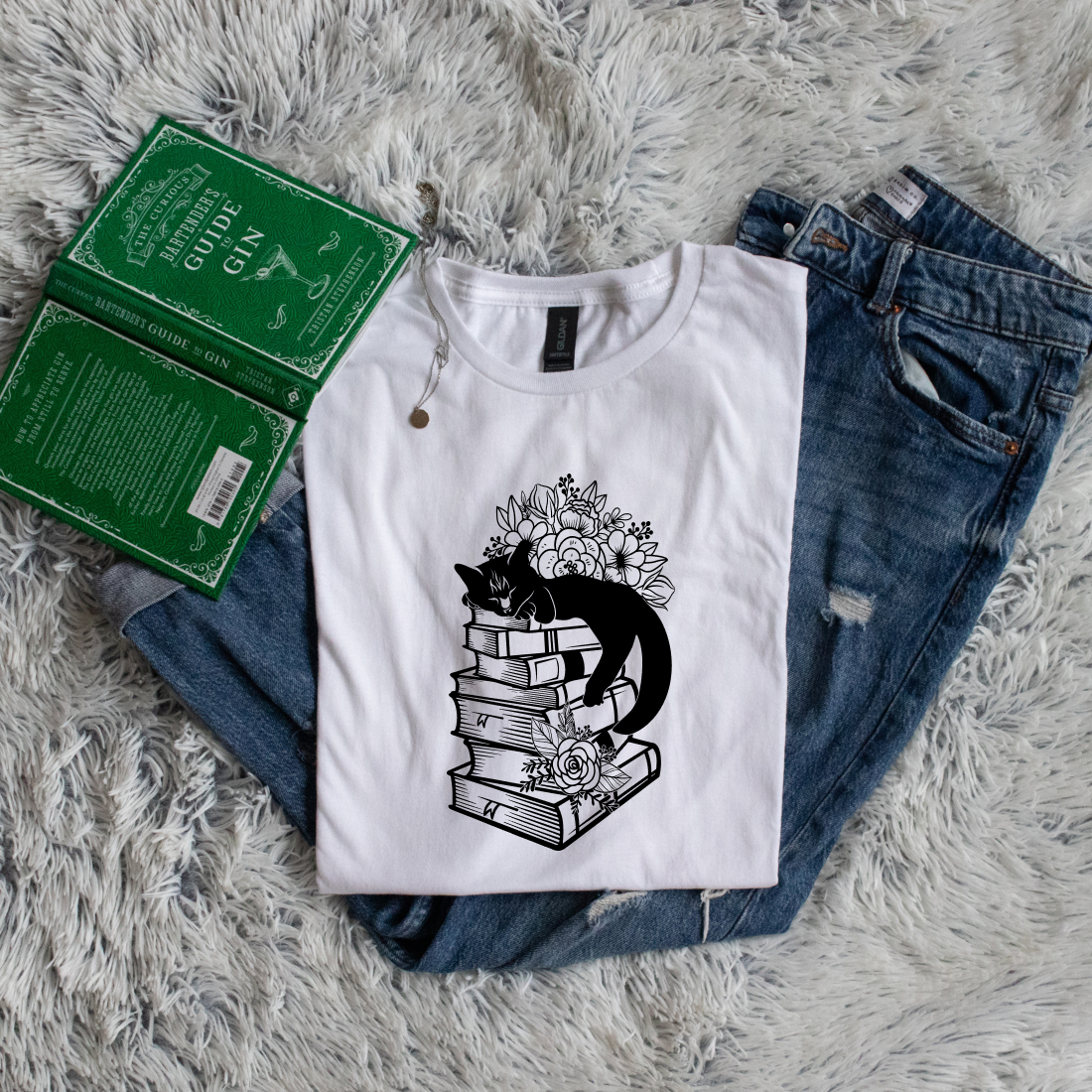 Cat sleeping on books flowers